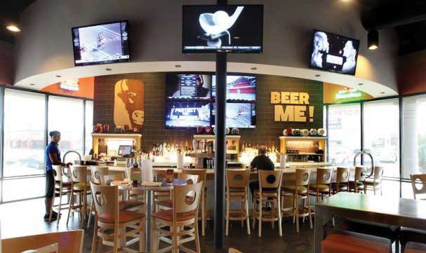 Buffalo wild wings interior bar area with stools and tvs