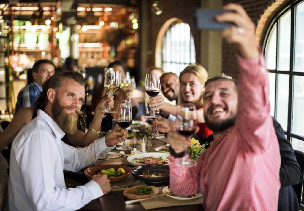 group photo selfie millennials at nice restaurant