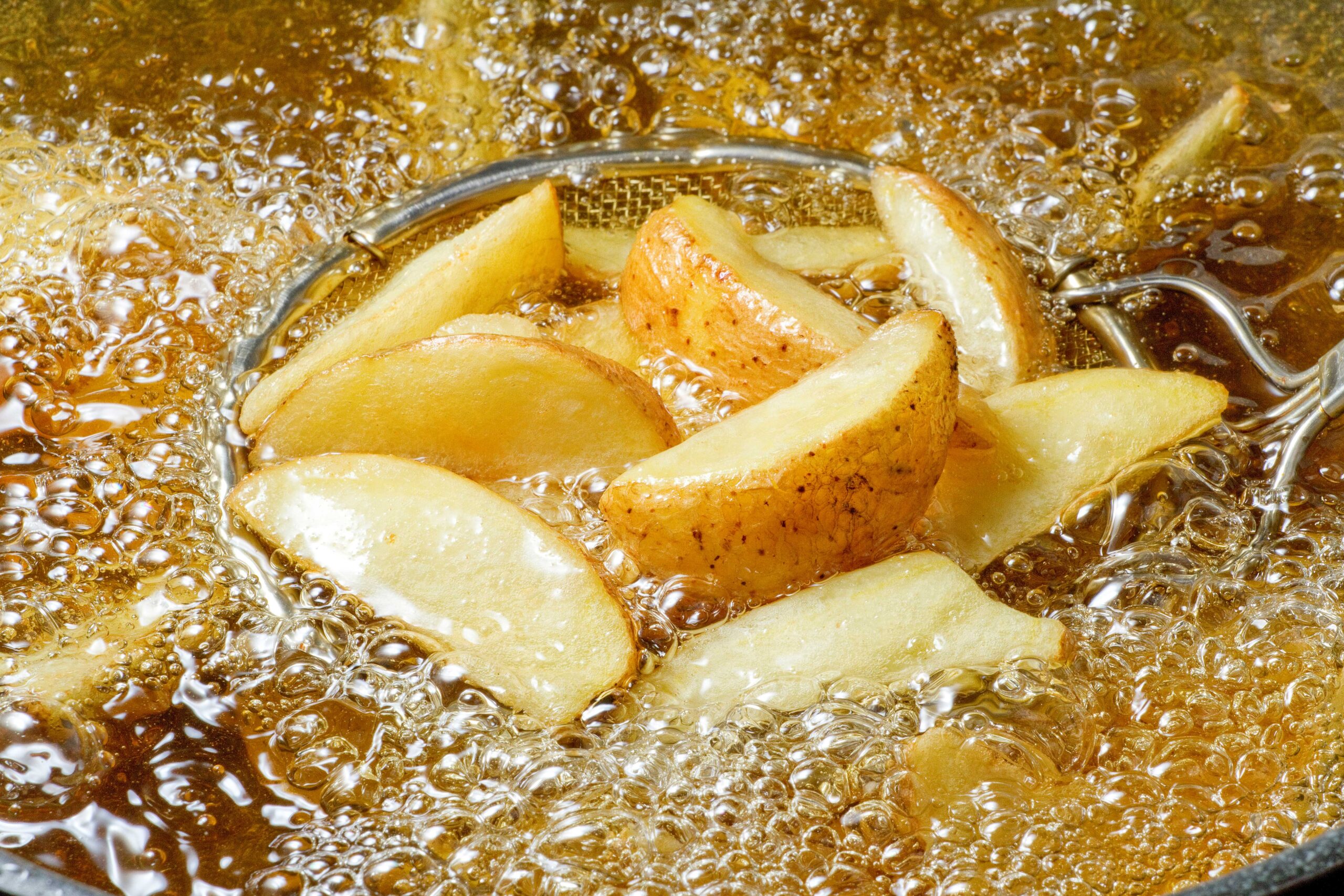 Potato wedges in fryer oil