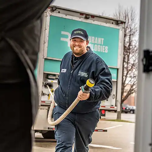 Man delivering cooking oil through Restaurant Technologies nationwide.