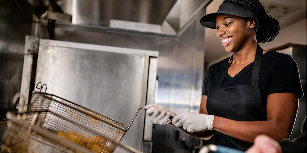 Smiling worker at fryer