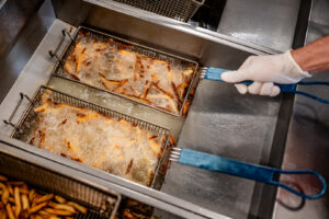 French fry baskets in fryer